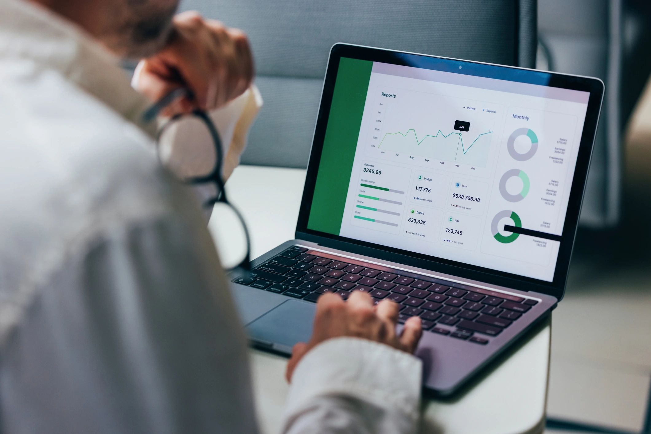 Person analysing business data on a laptop